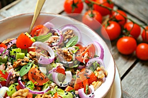 Detox ,vegan , raw salad with tomato, onions and walnuts photo