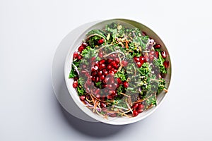 Detox vegan salad with kale, vegetables, pomegranate and tahini dressing