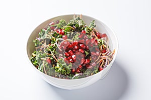 Detox vegan salad with kale, vegetables, pomegranate and tahini dressing