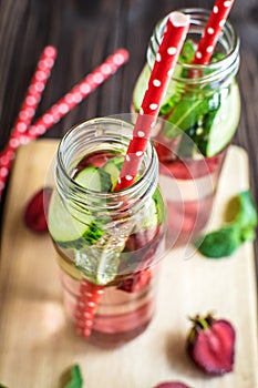 Detox water infused with fruits. Summer water fruit on rustic ba
