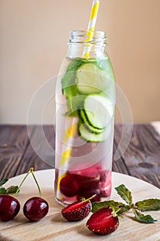 Detox water infused with fruits. Summer water fruit on rustic ba