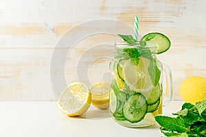 Detox water infused with sliced lemon, cucumber and sprigs of mint