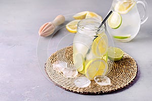 Detox Water With Lemon amd Lime and Ice Tasty Summer Lemonade Drink with Ice Cube Detox Healthy Drink Vertical Infused Water photo