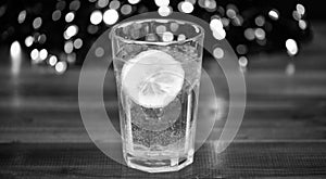 Detox after winter party. Health care concept. What to drink on christmas party. Cocktail glass with water and slice of