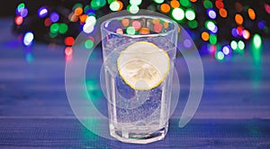 Detox after winter party. Health care concept. What to drink on christmas party. Cocktail glass with water and slice of