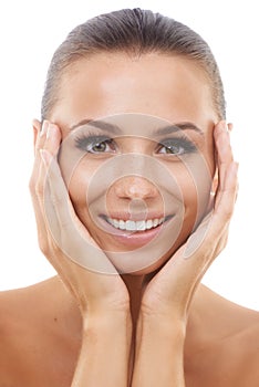 Detoxing did her skin a world of good. Beautiful young woman touching her face while isolated against a white background