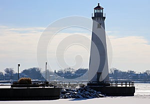 Detroit riverfront lighthouse during cold winter facing Canada