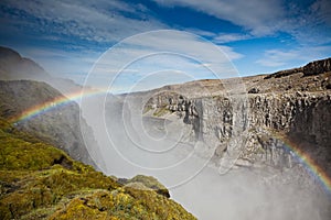 Dettifoss Waterfall in Iceland under a blue summer sky with clouds