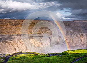 Dettifoss waterfall and rainbow, Iceland. Famous place in Iceland. A mountain valley and clouds after rain. Natural landscape in s
