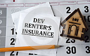 DEV RENTERS INSURANCE - word on white paper on the background of a house, pencil and calendar photo