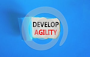 Develop agility symbol. Concept words Develop agility on beautiful white paper on a beautiful blue background. Business, support