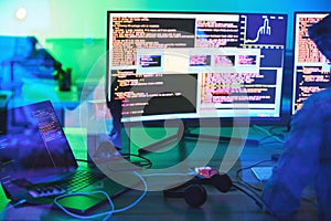 Developer, code or computer screen in neon programming, cybersecurity ransomware or SEO night phishing in basement