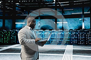 Developer in data center updating systems using laptop