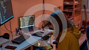 IT developer eating food while programming script