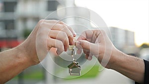 The developer passes the key of the new home to the buyer.