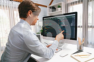 IT developer pointing on coding software on pc comparing laptop. Pecuniary.