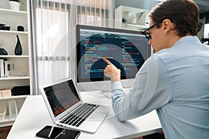 IT developer pointing on coding software on pc comparing laptop. Pecuniary.
