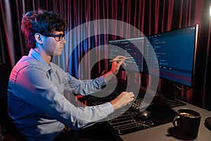 IT developer pointing online software information coding on pc screen. Gusher.