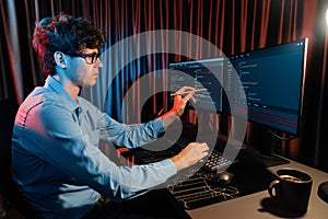 IT developer pointing online software information coding on pc screen. Gusher.