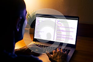 Developer programmer writing html javascript code in a laptop
