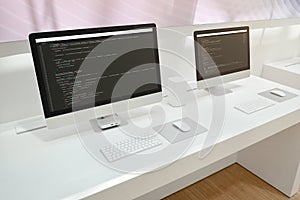 Developer`s office. Two computer displays with code editors