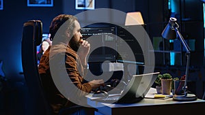 Developer typing code in home office to develop software application