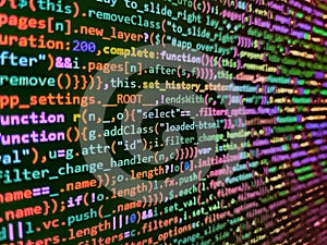 Developer working on program codes. Closeup of Java Script and HTML code. Close up of computer web page code inside of html file.