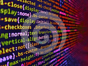 Developer working on program codes. Simple website HTML code with colourful tags in browser view on dark background. Digital