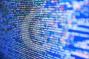 Developer working on software codes in office. Hi-tech modern screen of data, digits and chars on monitor. HTML5 in editor for