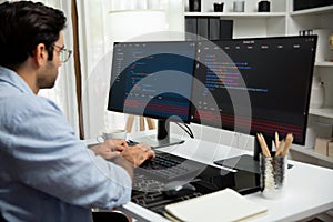Developer working software development coding two computer code screen. Surmise.