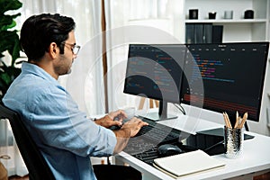 Developer working software development coding two computer code screen. Surmise.
