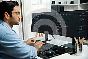 Developer working software development coding two computer code screen. Surmise.