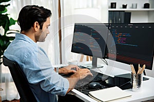 Developer working software development coding two computer code screen. Surmise.