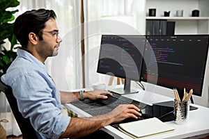 Developer working software development coding two computer code screen. Surmise.
