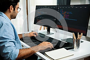 Developer working software development coding two computer code screen. Surmise.