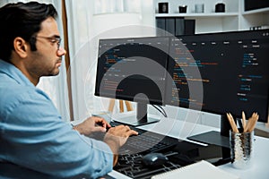 Developer working software development coding two computer code screen. Surmise.