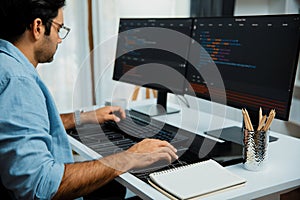 Developer working software development coding two computer code screen. Surmise.