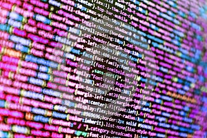 Developer working on source codes on computer at office. Data encryption security code on a computer display, close up. Abstract