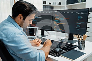 IT developer writing data memo software development on paper's coding. Surmise.