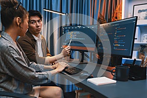 IT developers discussing with point website coding system. Infobahn.