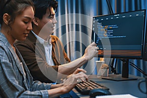 IT developers discussing with point website coding system. Infobahn.