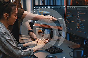 IT developers discussing with point website coding system. Infobahn.