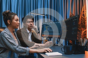 IT developers discussing with point website coding system. Infobahn.