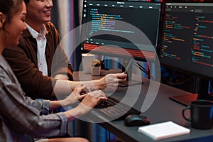 IT developers discussing with point website coding system. Infobahn.