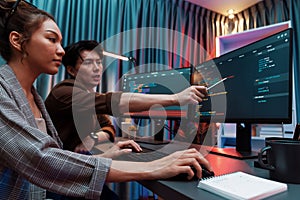 IT developers discussing with point website coding system. Infobahn.