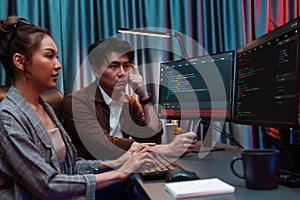 IT developers discussing with point website coding system. Infobahn.