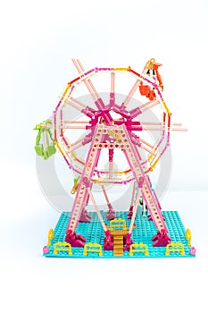 Developing children\'s designer. Ferris wheel with puppet men. Isolated on white background. Lego