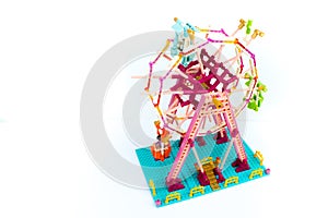 Developing children\'s designer. Ferris wheel with puppet men. Isolated on white background. Lego