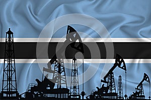 Developing Flag of Botswana. Silhouette of drilling rigs and oil rigs on a flag background. Oil and gas industry. The concept of