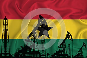 Developing Flag of Ghana. Silhouette of drilling rigs and oil rigs on a flag background. Oil and gas industry. The concept of oil